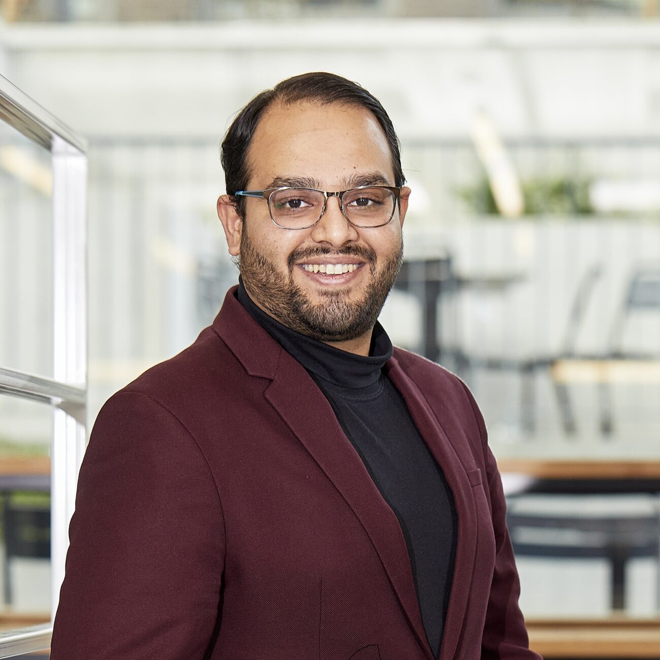Ali Bin Junaid, founder of Effecon, standing in a modern workspace